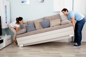 Man and woman moving a couch