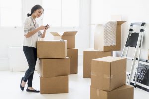 young woman standing among boxes
